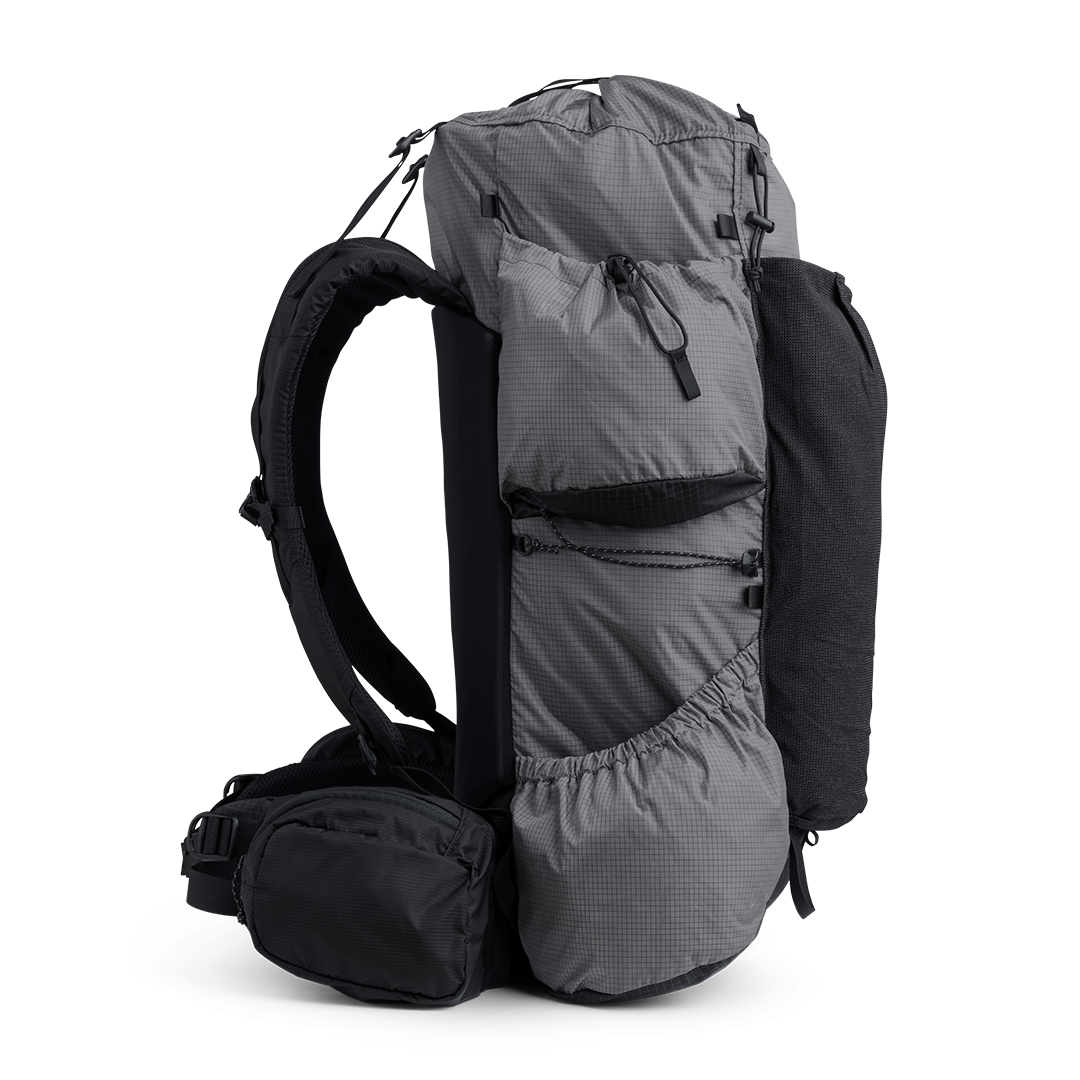Side view of the Outdoor Vitals Shadowlight backpack showing large side pockets, hip belt pocket, and streamlined suspension system.